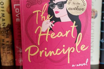Cover of The Heart Principle depicting a woman with long black hair, wearing black sunglasses, and wearing pink lipstick